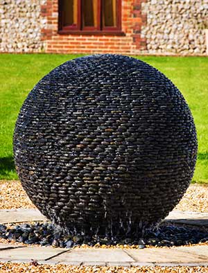 Dark Planet Fountain at the centre of a garden circle