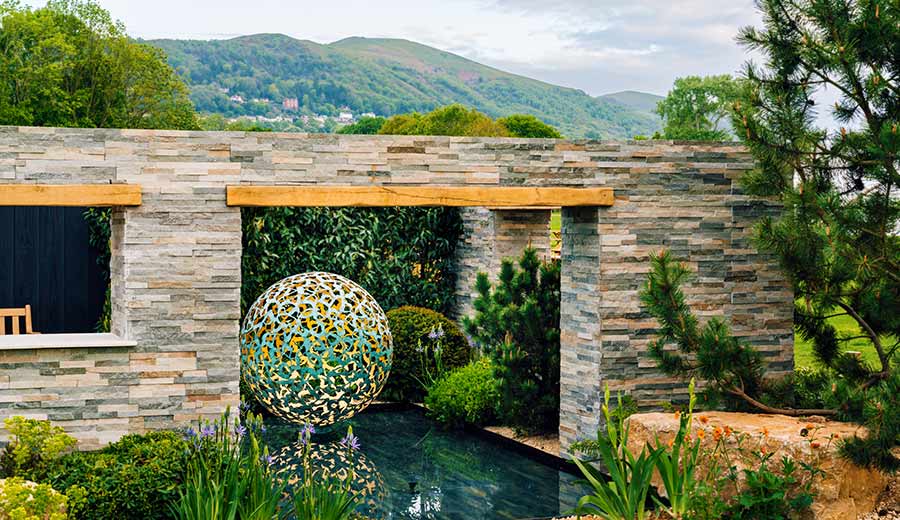 Mantle sculpture at RHS Malvern Spring Festival with beautiful views of the Malvern Hills