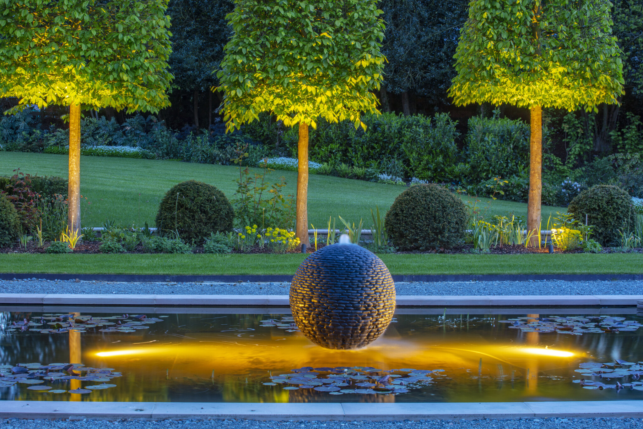 Dark Planet stone garden sphere lit up at night