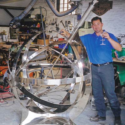 Drinking champagne while making an armillary sphere in our messy old workshop