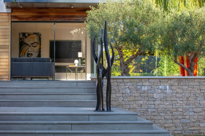 Organic, seaweed-like sculpture with an architectural design in a modern house setting.
