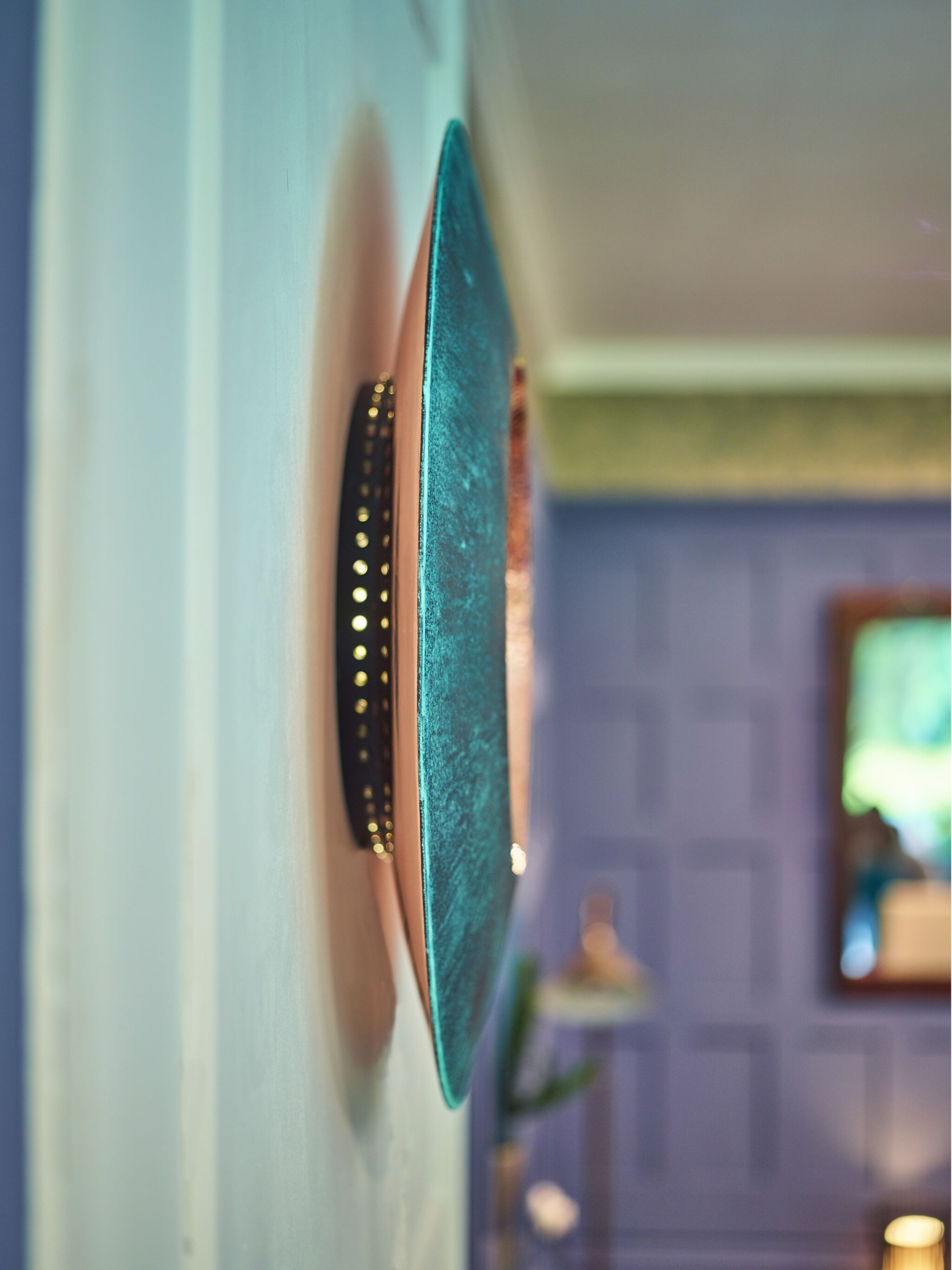Side profile of a wall-mounted mirror artwork with backlighting