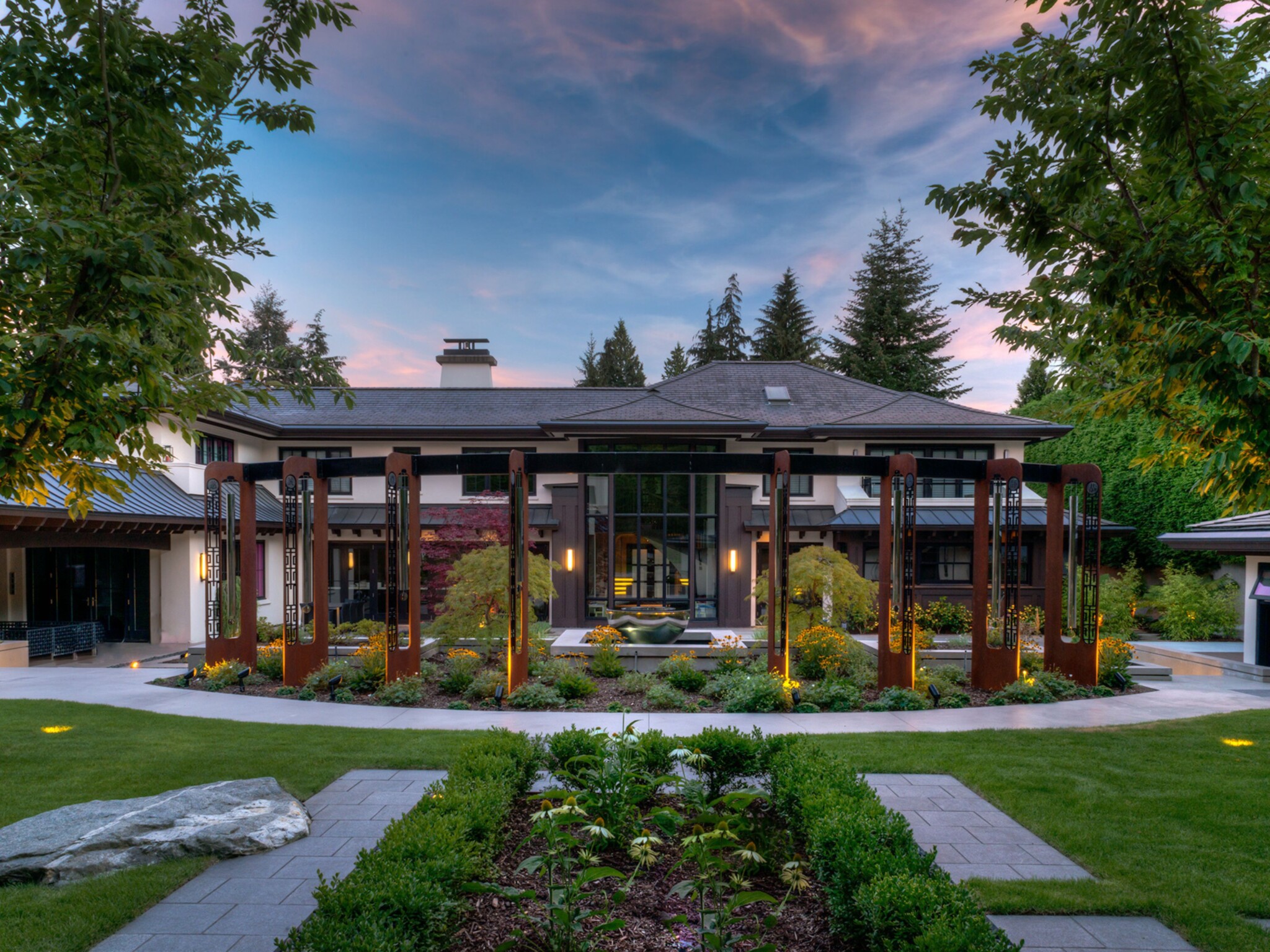 Oxidised steel planels hous stainless steel windchimes as part of a large outdoor sculpture.