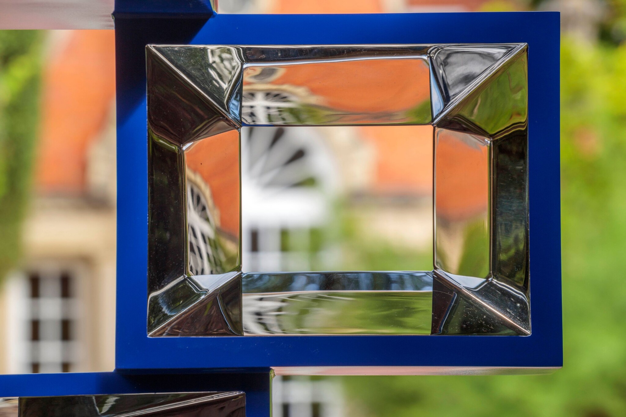 View through a single section of a Corbusier inspired stainless-steel cube sculpture by British artist, David Harber