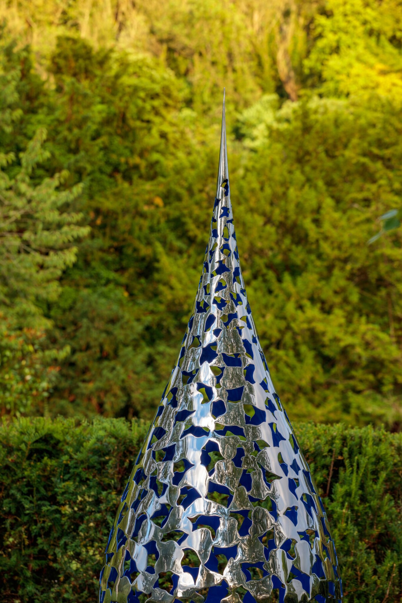 Mirrored metal sculpture with elegant spire