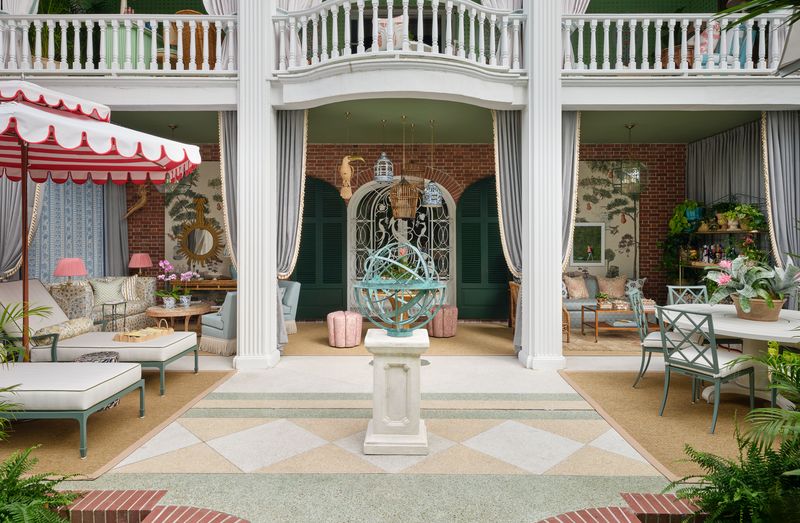 Elegant outdoor patio with columns, seating, plants, and courtyard garden ideas centred around a decorative sphere.