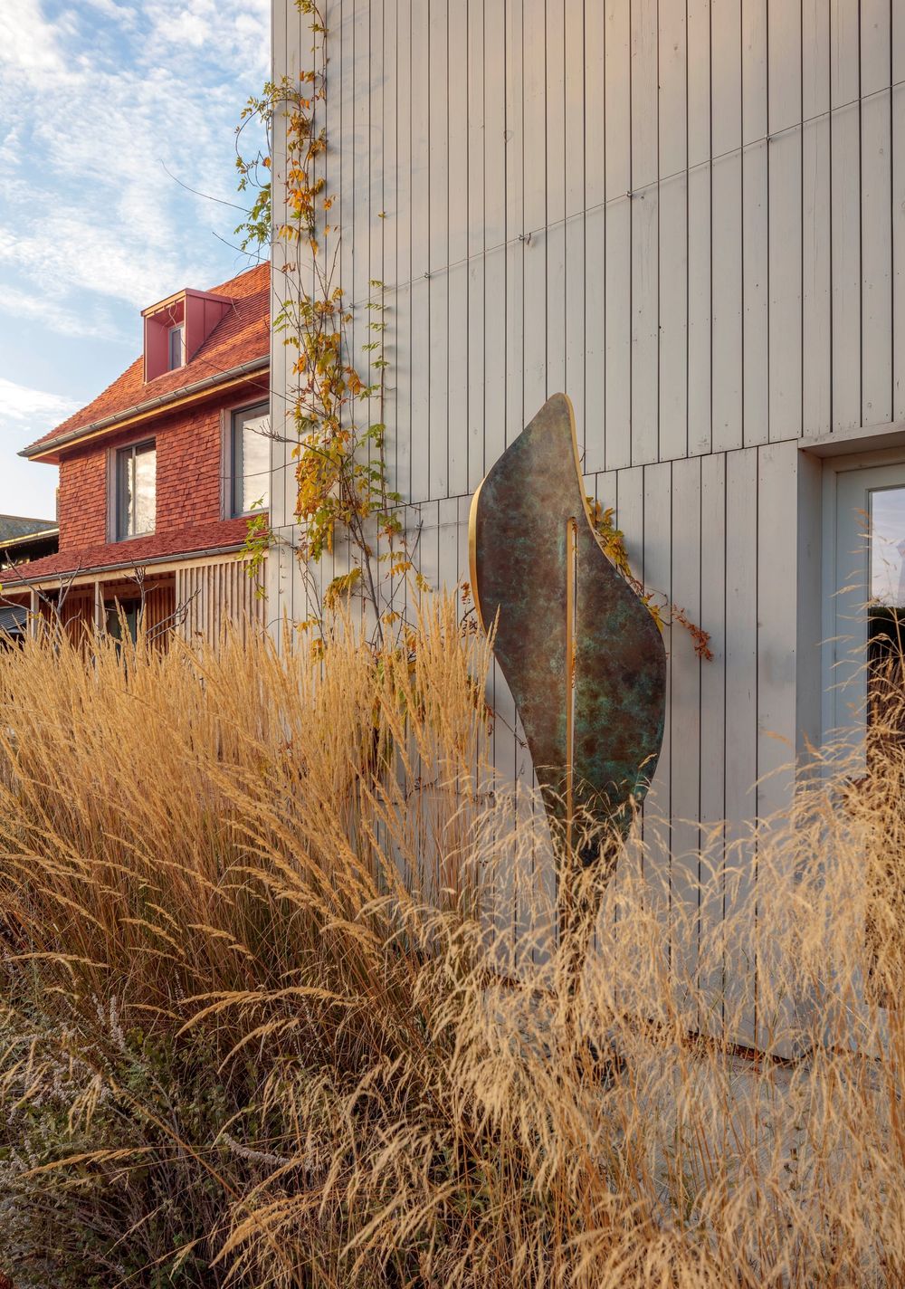 Flo sculpture featuring hot patination finish set in a rustic landscape