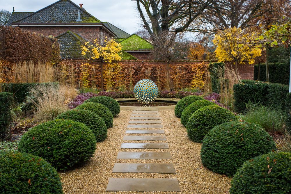 formal, symmetrical garden layout utilising a central stone or gravel path