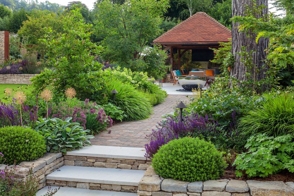 brick path leads to a wooden gazebo showcasing architectural garden design