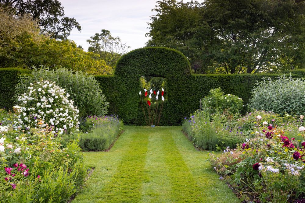 architectural garden design structure featuring symmetrically planted evergreens and ornamental shrubs
