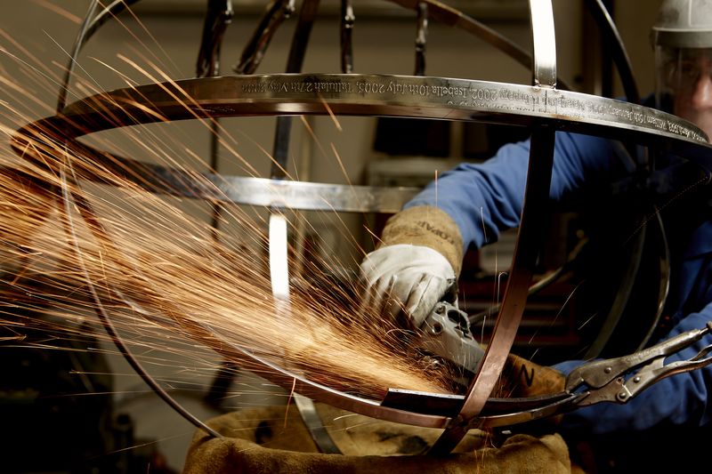workman welding armillary sphere